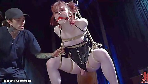 Sexy redhead shemale with a hot face and a hot body is tied up