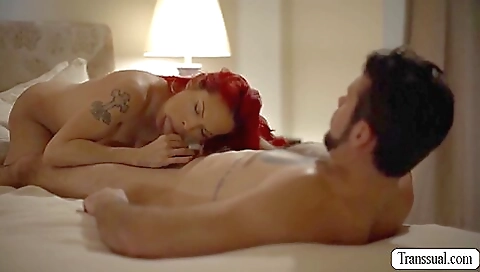 Big tits redhead with a tattooed body is stretching her asshole